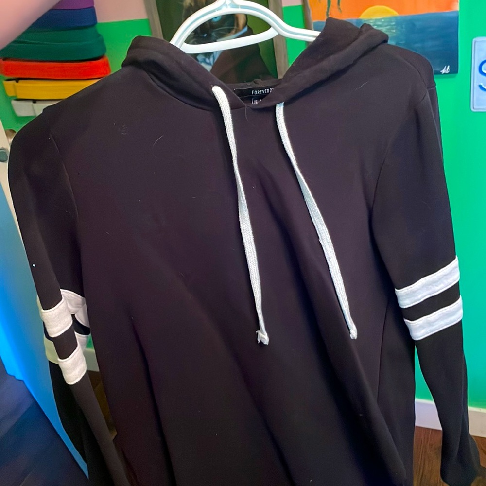 Black hoodie with white strips on the arms. Fit medium- large.